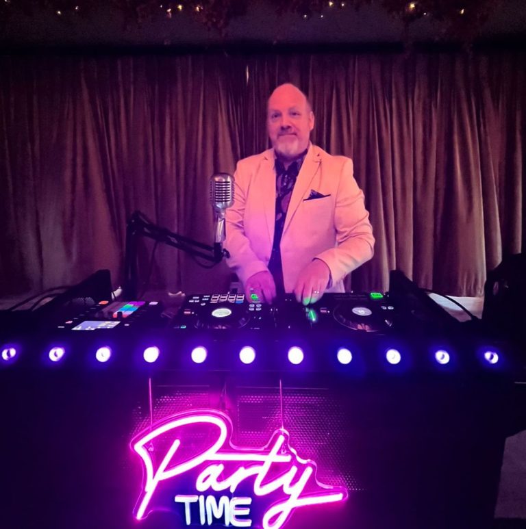 dj lloyd bracken behing the dj booth in action at a wedding