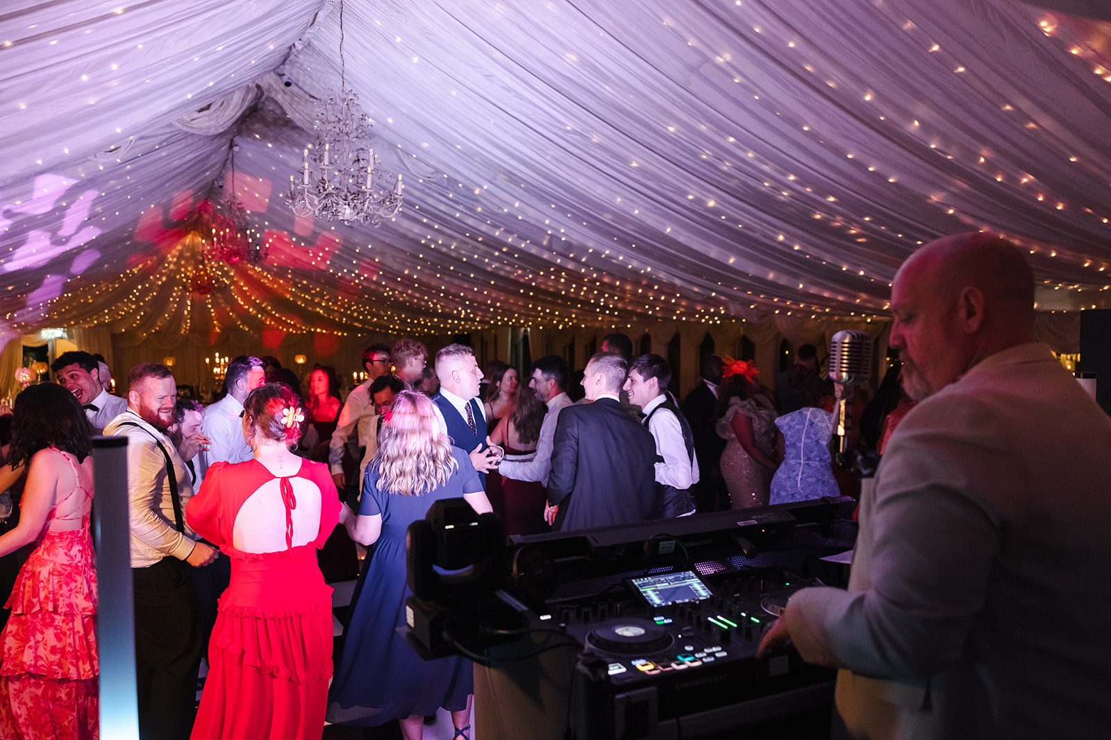 Wedding DJ Lloyd Bracken performing to a packed dancefloor at an Irish wedding reception